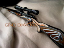 Carved Gunstock with suspended metal paints A more modern version of a fantastic gun carving